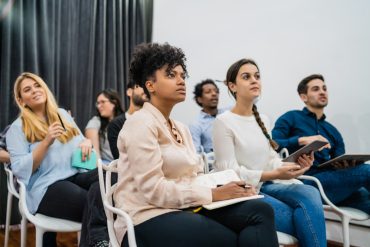 Group of creative business people listening to colleague addressing office meeting. Business and brainstorming concept. CONFERENCING